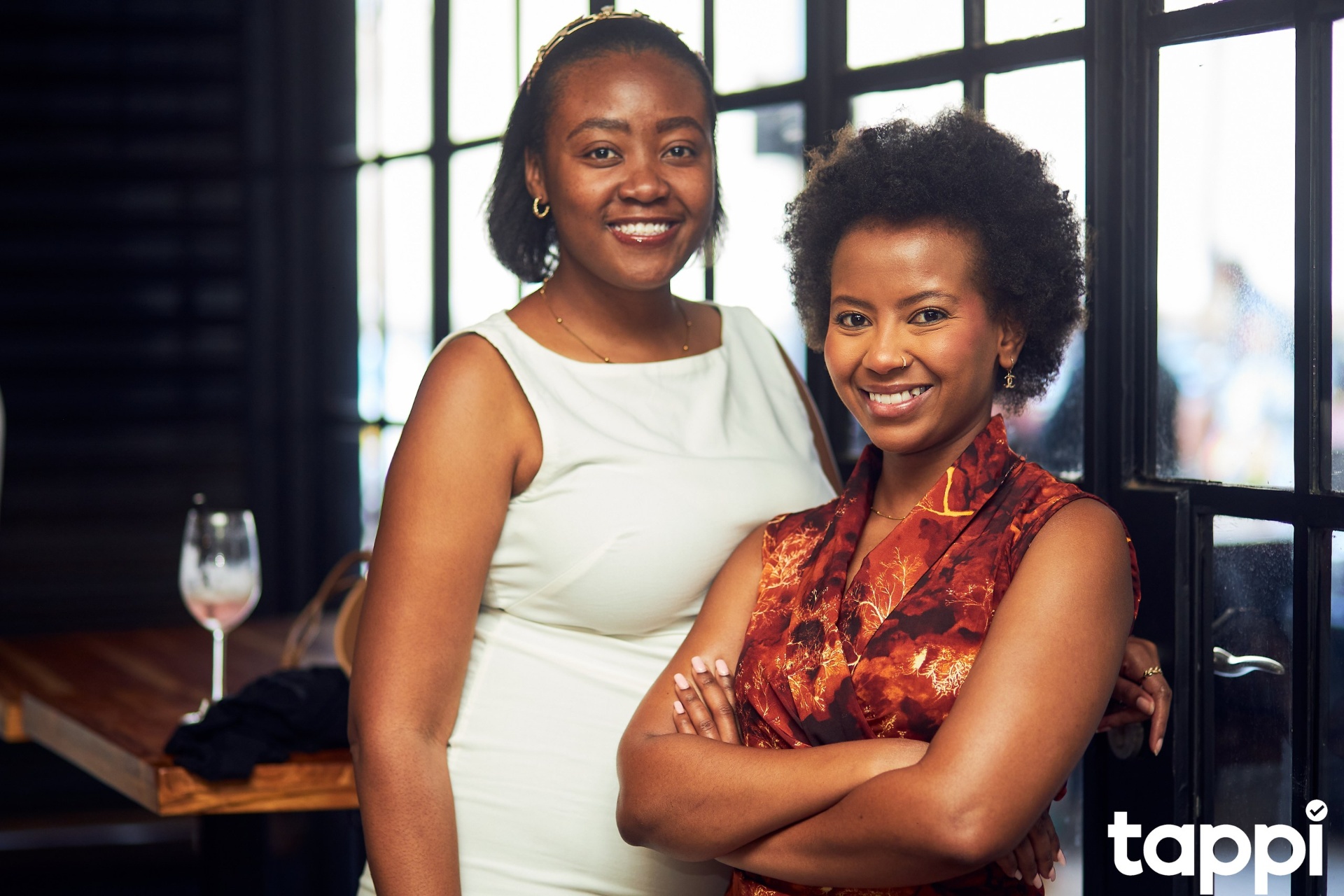 Two attendees smiling at a tappi event